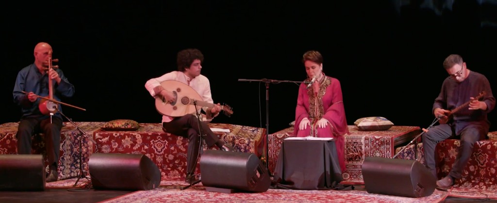 Parissa with ensemble on stage at Tirgan Festival, Toronto — kamancheh, oud, tar, and tombak on Persian rugs, July 2019